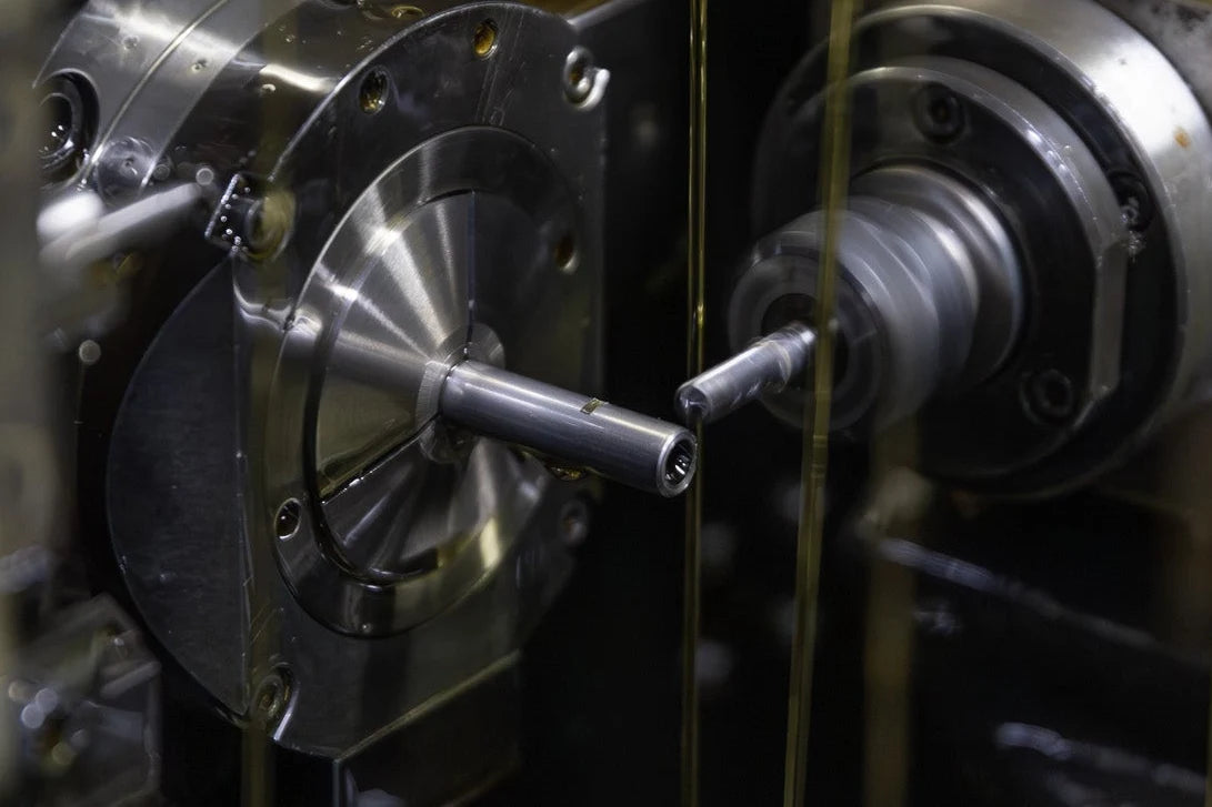 A precision CNC Swiss lathe machine in Japan cutting and milling the custom stainless steel hop-up window on a SPARK Hiei Kai inner barrel by da Vinci for AIRSOFT97.