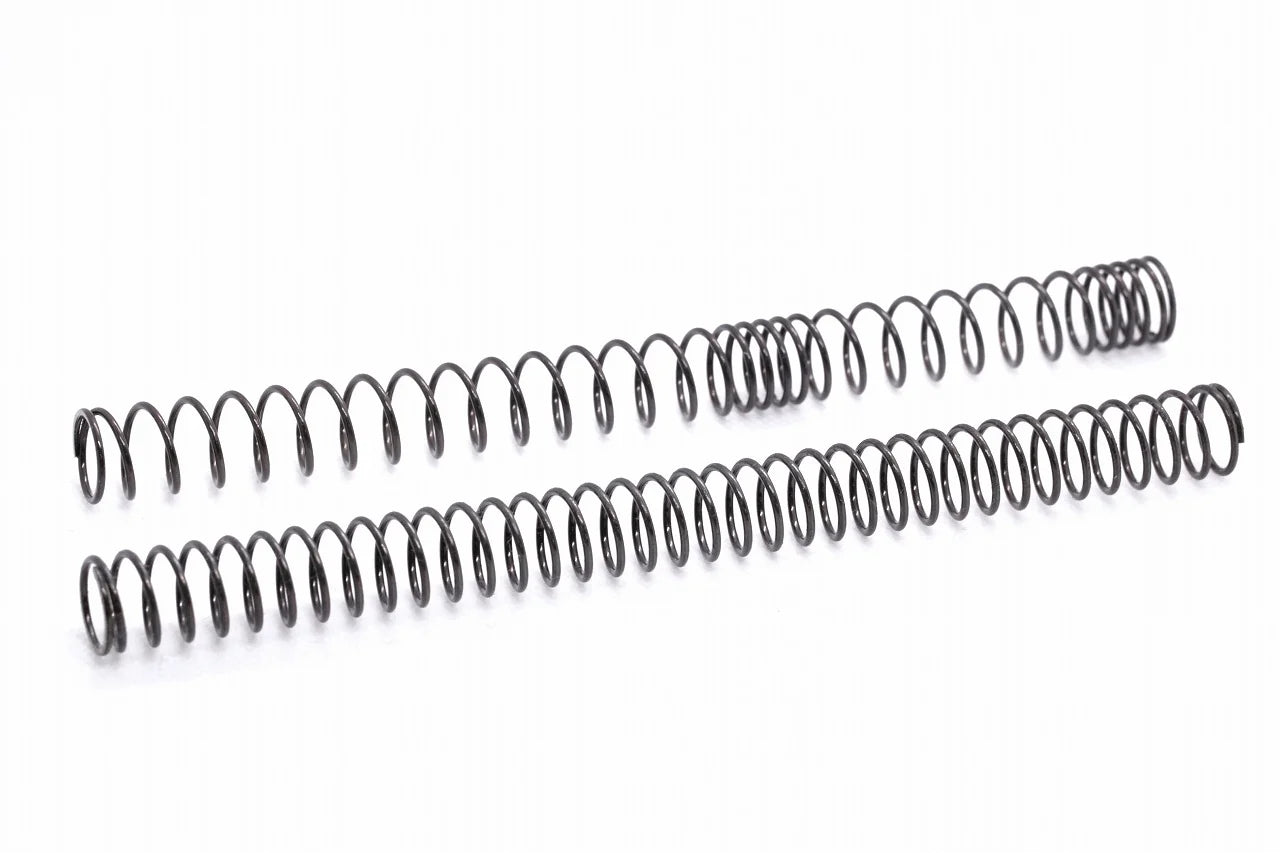 Two dark gray SPARK main springs for electric guns by AIRSOFT97, showing the physical difference between an irregular pitch non-linear coil layout and a standard linear compression spring coil configuration on a clean white background.