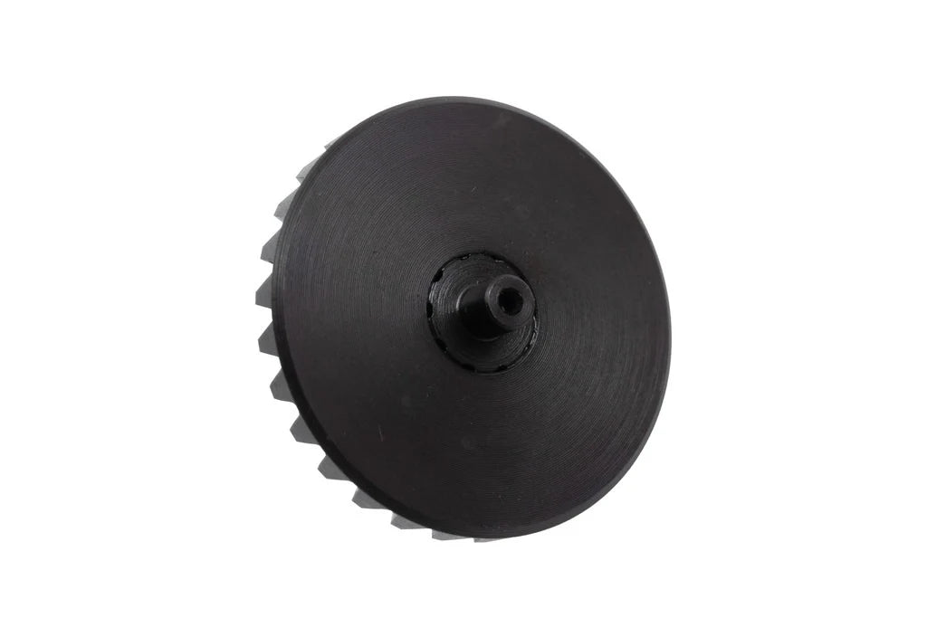 An angled perspective of the bottom side of the SPARK Extreme Bevel Gear Kai by AIRSOFT97, highlighting the 10-stop anti-reversal latch interface ring around the central shaft.