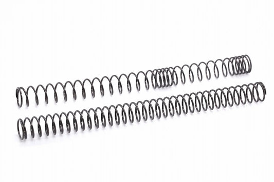 Two dark gray SPARK main springs for electric guns by AIRSOFT97, showing the physical difference between an irregular pitch non-linear coil layout and a standard linear compression spring coil configuration on a clean white background.